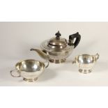 A silver three piece bachelor tea service, by Barker Bros, Chester 1919/21, of circular form with