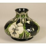 A Moorcroft green, white and black vase, with flower detail, stamped to base and dated 2003 13 cm