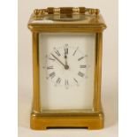 A brass striking carriage clock, white enamel dial with Roman numerals, the movement signed