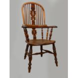 A Victorian ash and elm Windsor armchair, with pierced vase splat, raised on turned legs, scroll