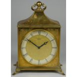 A Junghans Meister brass mantle clock, decorated with a floral design, the silver chapter ring