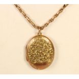 An Edwardian 9ct rose gold oval locket/pendant, Chester 1907, with engraved floral decoration 32 x