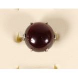 A white gold and cabochon garnet dress ring, unmarked, probably 14K, diameter 13mm, diamond set