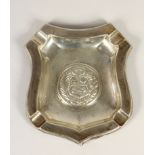 A silver ash tray, stamped STERLING 925, embossed with a family crest, 14 x 13cm, 2.5oz