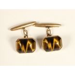 A pair of 9ct rose gold and tigers eye cufflinks, stamped 9ct, rectangular cabochon stones15 x 12mm,