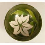 A Moorcroft green glazed bowl with white lily, signed signature to base, 7 x 16 cm