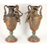 A pair of spelter vases, mounted on red marble, two handles, decorative figures and floral