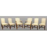 A set of six upholstered mahogany dining chairs, the pair of carvers with sweeping arms, together