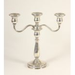A silver two branch, three light candelabra, stamped STERLING, with baluster column, floral band