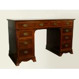 An Edwardian mahogany pedestal desk, two frieze drawers over three three drawer