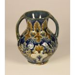 A Doulton Lambert two handled vase, in a cobalt blue, gold and white floral detailing, stamped to