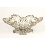 A Victorian silver pierced and embossed bowl, by William Comyns, London 1891, raised on a cast base,