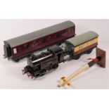 A clockwork 'O' gauge model railway items, including locomotive, 2 carriages, signal