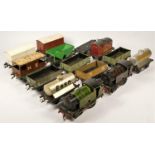 Two suitcases of 'O' gauge clockwork model railway items, to include track, engines, wagons, coaches