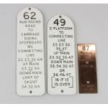 Three signal-lever identification plates, one brass, two traffolite