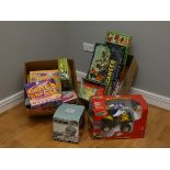 A boxed R/C Suzuki Trike, together with a collection of toys and board games.