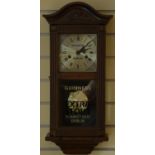 A mahogany cased manual wind wall clock, bearing 'Guinness Dublin' advertising to the dial.