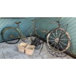 An early Triumph ladies bicycle, a penny farthing themed garden planter, a wooden cart wheel, a pair