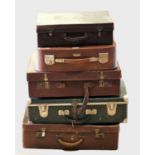 Five Mid Century suitcases to include leather bound examples. (5)
