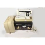 A 'Newhome' electric sewing machine and two leather attaché cases.