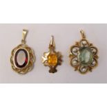 A 9ct gold and orange glass pendant, a gold pearl and pale stone pendant and a gold and red glass