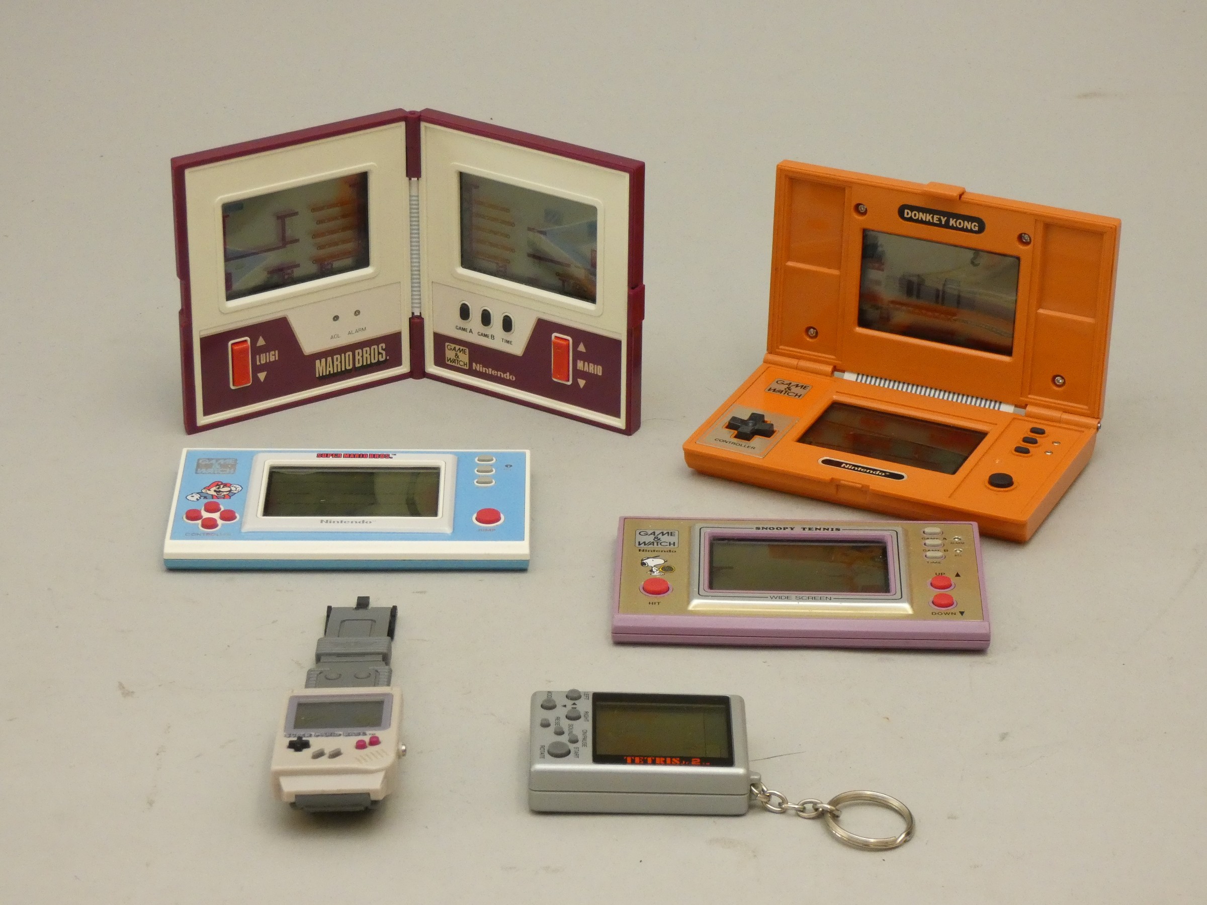 A collection of Nintendo Games and watch handheld games to include, Donkey Kong, Mario Bros.,