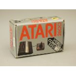 A boxed Atari 2600 serial number A17A3323975, complete with power supply unit, joystick, T.V