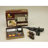 A boxed Tandy (60-9005A), with instrustion manual, power leads, a combination game rifle and pistol,