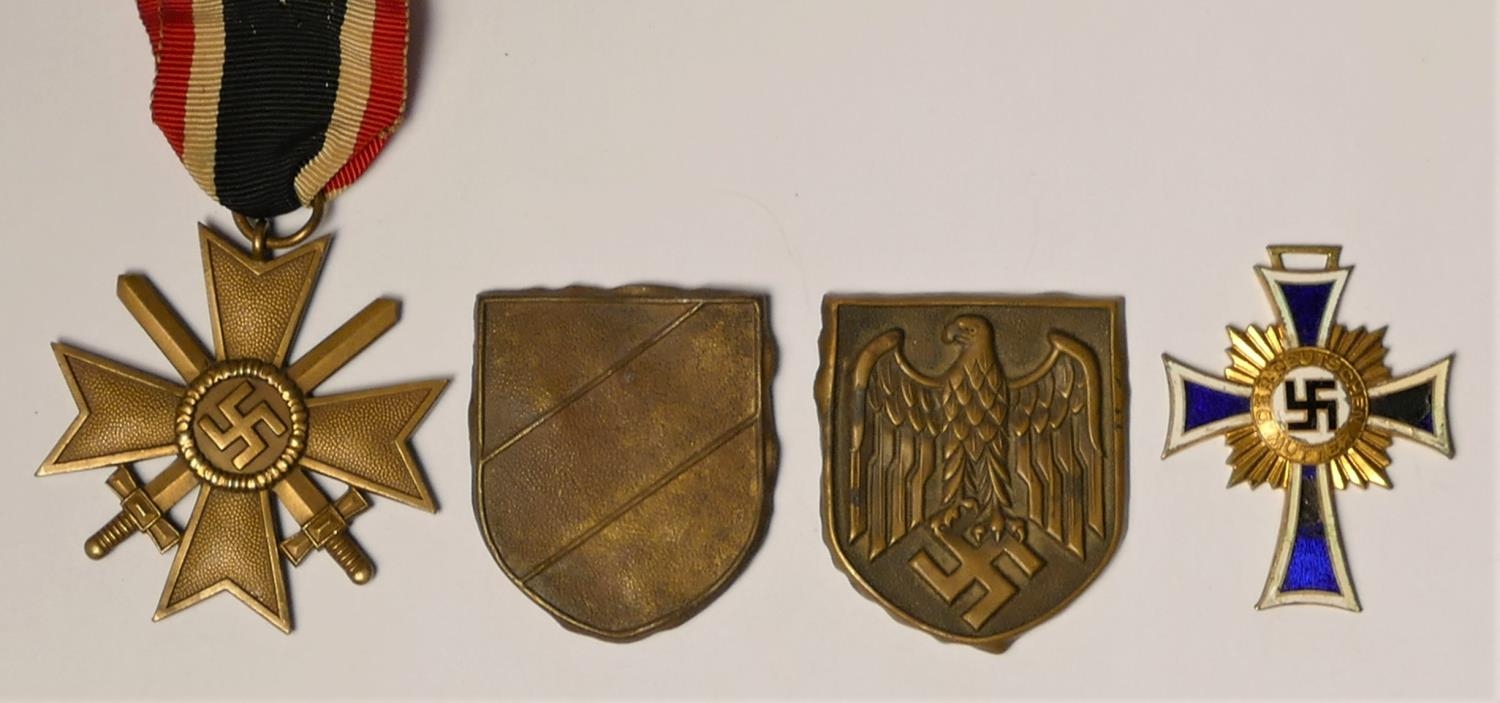 WWII German Mother Cross in gold, Merit Cross with swords and tow Pith helmet badges