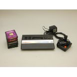 An Atari 2600 Model number CX-2600JR, complete with power supply, joystick, TV connection lead and a