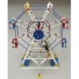 Meccano display model of a Ferris Wheel, built by using yellow, white and blue parts, motorised.