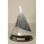 A Parker Sailboat strike table lighter, chrome sails and deck, ebonised hull and base,