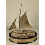 An electoplated sailing presentation trophy, in the form of a gaff rigged, clinker built, vintage