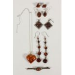 Four pairs of silver mounted amber ear rings, a brooch and a pendant