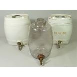 A mid 20th century glass barrel spirit dispenser, two ceramic versions together with a Royal