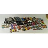 A collection of play worn diecast cars, trains, planes and other vehicles, also including track