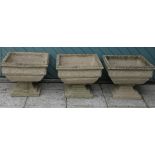 Three composite garden planets, on raised bases with floral carved decoration, height - 43cm,