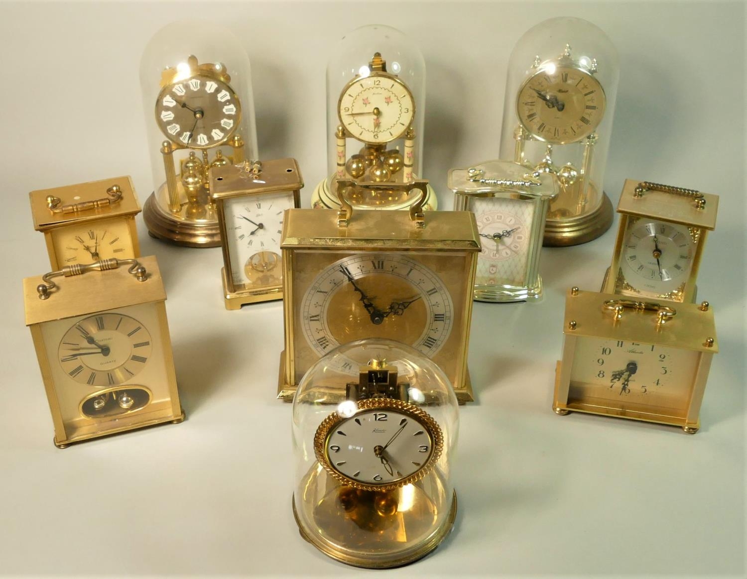 A brass cased kundo anniversary mantle clock together with a collection of barometers and carriage