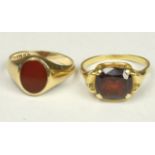 An 18ct gold and garnet single stone ring, R, 4.3gm and a 9ct gold single stone ring, P, 2.7gm