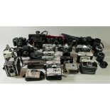 A collection of cameras and accessories, including brands such as Minolta, Polaroid and Pentax