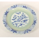 A Kang Si blue and white charger, with central bird and foliage design, floral wavy boarder,
