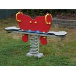 A Playdale outdoor/playground springer seesaw in the form of a butterfly, made from high density