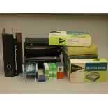 A collection of 35mm slide holders, 35mm film storage folders, slide wheels and empty photo