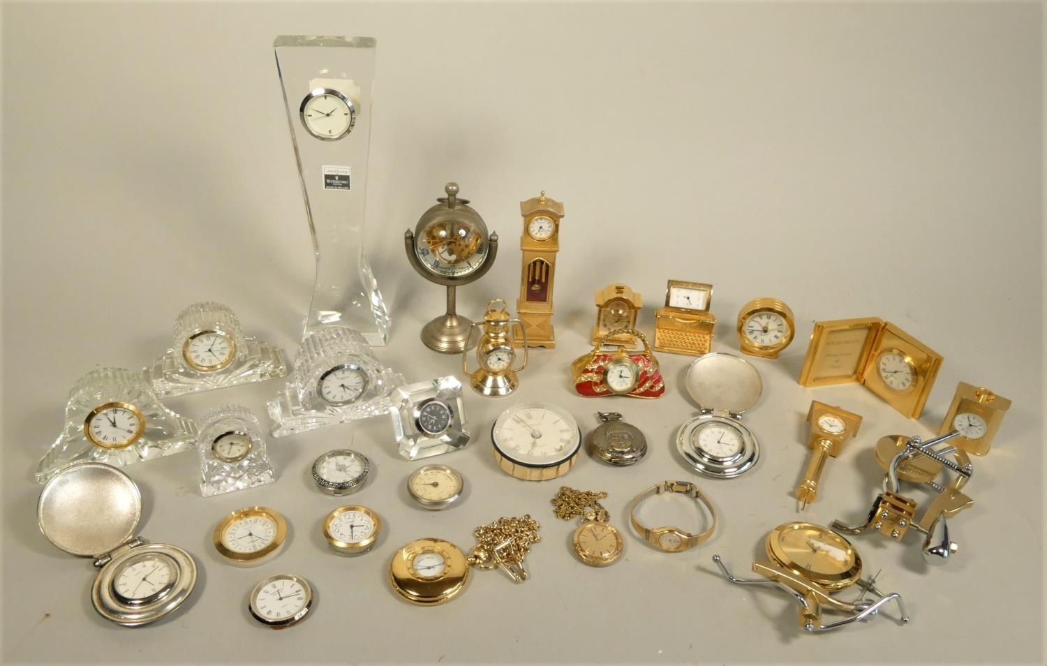 A collection of miniature novelty clocks including Waterford crystal, together with carriage, wall
