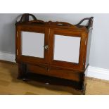 An Edwardian mahogany wall cabinet, pieced fretwork to top and bottom, glazed doors with lock and
