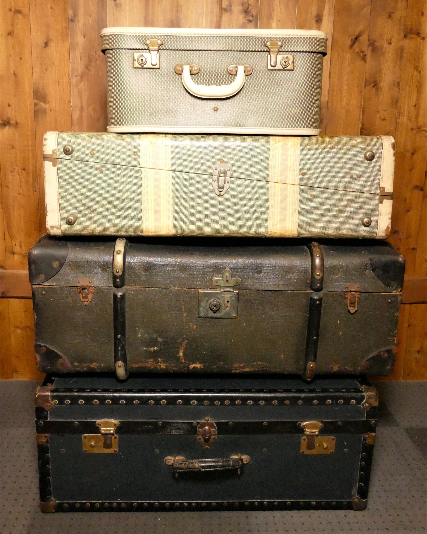 Mid Century shipping/traveling cases together with an early wood & brass bound sailor's trunk. (4)