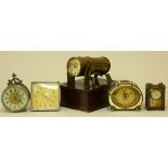 A collection of five desk clocks, including a novelty projection clock, a small carriage depicting