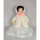 An early Century German bisque doll with blue sleep eyes, articulated tongue and composite body,