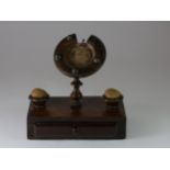 A Victorian mahogany pocket watch stand, in the shape of a horseshoe, flanked by padded pin holder