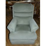 A manual recliner armchair in pale green pattern chenille fabric. 105cm high, 76cm wide.
